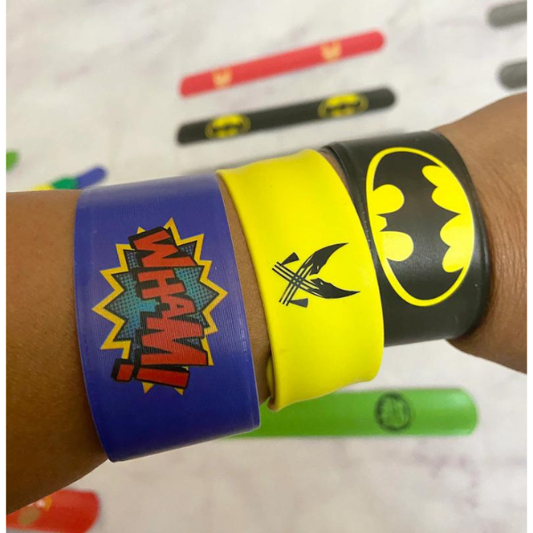 Childs wrist with 3 superhero slapbands on