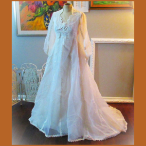 a white 1970's vintage wedding dress on a manikin