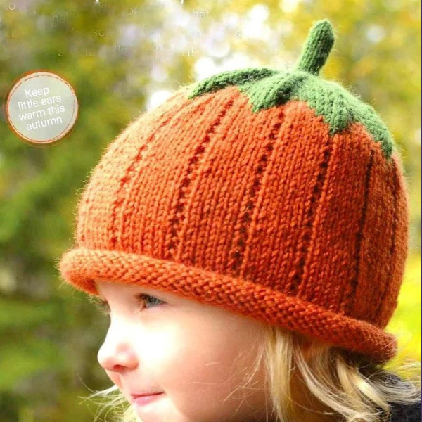 Child wearing a wooleen pumpkin shaped hat