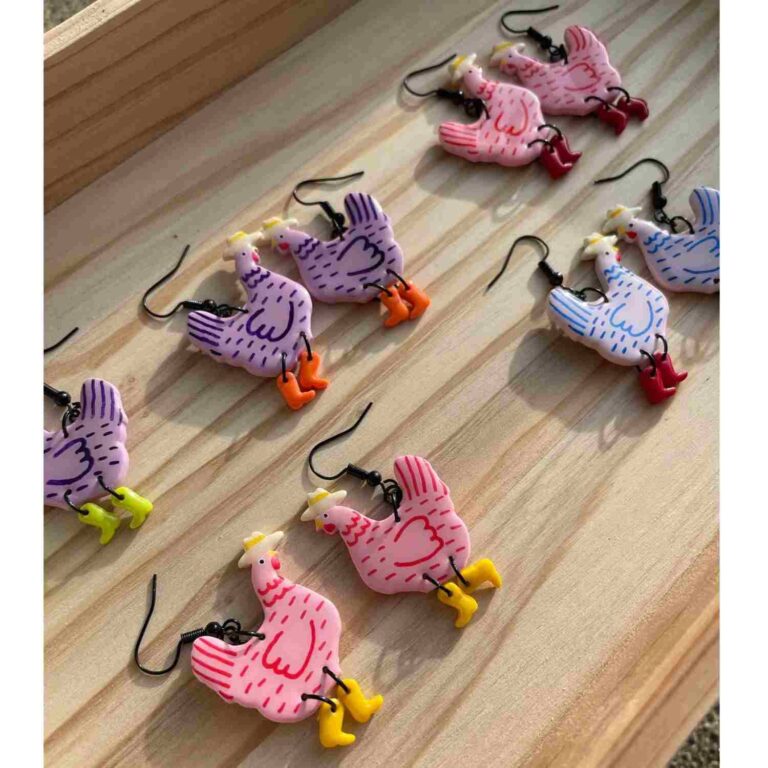 colourful earrings where the design is of a chicken dressed as a cowboy